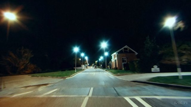 Video Reference: night, street, road, driving, streetlights, residential, empty road, vehicle, outdoors, dark, suburban, intersection, motion blur, urban