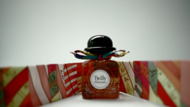 Video Reference: pack, product, scent, perfume, white background, studio, tape, closeup, close up, Person