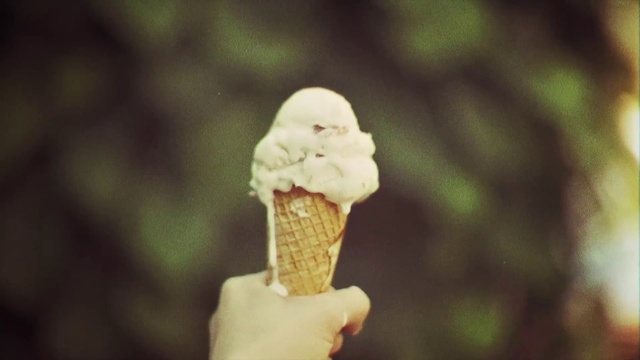 Video Reference: Ice cream cone, Gelato, Ice cream, Frozen dessert, Sorbetes, Dondurma, Dessert, Dairy, Food, Soft serve ice creams, Holding, Woman, Snack, Fast food, Baked goods, Cake, Soy ice cream, Vanilla ice cream, Frozen yogurt, Muffin, Chocolate, Delicious, Blur