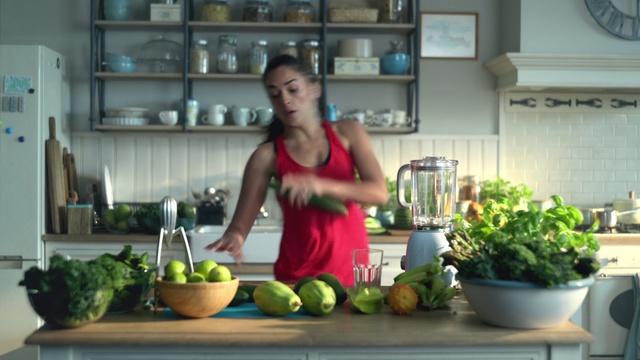 Video Reference: Natural foods, Vegetable, Food, Local food, Plant, Vegetarian food, Leaf vegetable, Whole food, Vegan nutrition, Herb, Kitchen, Person, Woman, Indoor, Table, Counter, Green, Standing, Preparing, Bowl, Holding, Wearing, Girl, Young, Cutting, Large, Sink, Red, Cooking, Board, White, Plate, Phone, Stove, Man, Fruit, Healthy, Kitchen appliance, Bottle, Mixing bowl, Apple, Watermelon