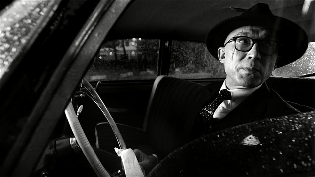 Video Reference: car, black, photograph, black and white, motor vehicle, photography, glasses, vision care, eyewear, automotive design, Person