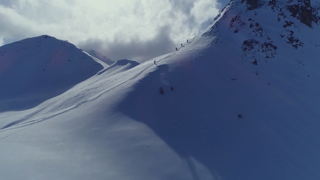 Video Reference: mountain range, ridge, mountainous landforms, sky, snow, piste, mountain, geological phenomenon, arête, glacial landform