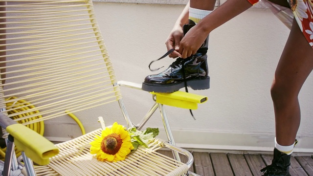 Video Reference: Yellow, Footwear, Sunflower, Leg, Shoe, Vehicle, Flower, Plant, Human leg, Chair
