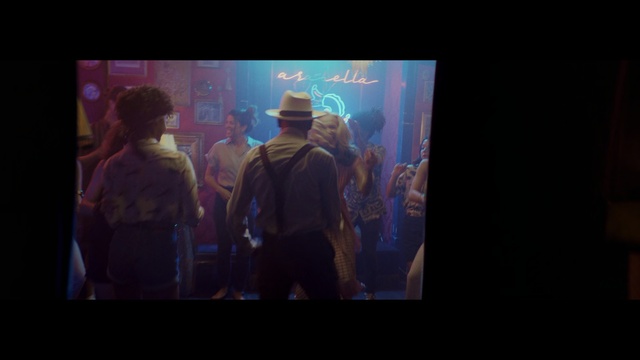 Video Reference: Photograph, Light, Darkness, Fun, Performance, Event, Design, Crowd, Magenta, Stage, Television, Person, Monitor, Screen, Indoor, Man, Standing, Front, Watching, Video, Photo, Looking, People, Holding, Woman, Room, Living, Dark, Group, Display, Large, Playing, Game, Computer, Wii, Remote, Aquarium, Text, Clothing