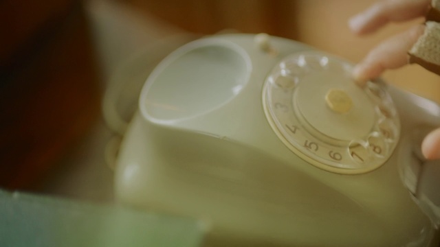 Video Reference: Drinkware, Indoor, Cup, Telephone, Table, Cake, Sitting, Plate, Spoon, Small, Food, Holding, White, Brush, Teeth, Tableware, Saucer, Dishware, Platter, Serveware, Coffee cup, Porcelain, Bowl, Ceramic, Kitchen utensil, Lid, Mixing bowl, Dairy, Mug