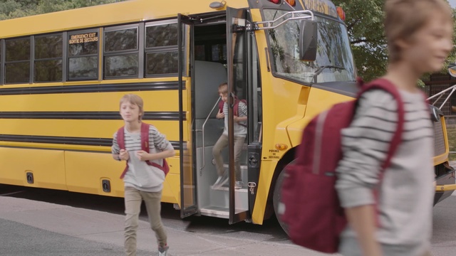 Video Reference: yellow, bus, transport, vehicle, school bus, mode of transport, public transport, Person