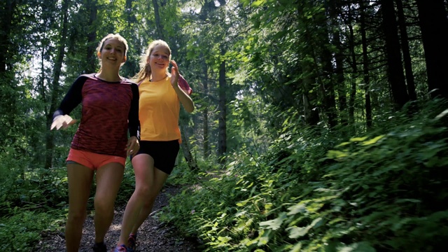 Video Reference: People in nature, Nature, Natural landscape, Forest, Green, Natural environment, Tree, Old-growth forest, Woodland, Biome, Outdoor, Woman, Person, Grass, Wood, Wooded, Standing, Walking, Young, Girl, Path, Holding, Lady, Trail, Carrying, Posing, Female, Wearing, Field, Riding, Park, Frisbee, Suitcase, Water, Hill, Playing, People, Clothing, Shorts, Hiking, Plant