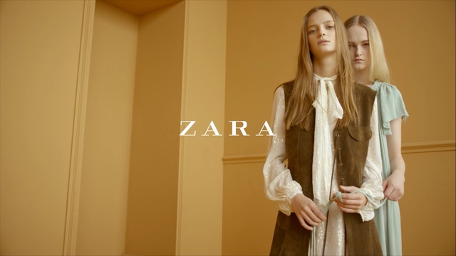 Video Reference: Clothing, Yellow, Outerwear, Blond, Fashion, Long hair, Dress, Textile, Beige, Formal wear, Person