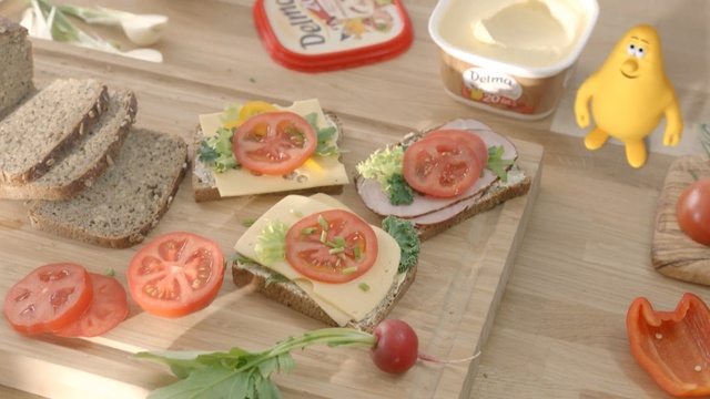 Video Reference: Food, Dish, Cuisine, Ingredient, Produce, Finger food, Recipe, Lunch, Breakfast, Meal, Person, Table, Indoor, Cake, Wooden, Sitting, Plate, Slice, Cutting, Board, Sliced, Piece, Fruit, Bread, Different, Chocolate, Bowl, Sandwich, Cut, Many, Holding, People, Group, Vegetable, Fast food, Salad, Garnish, Tomato, Platter, Culinary art, Lemon