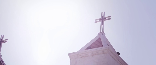 Video Reference: Cross, White, Steeple, Religious item, Atmospheric phenomenon, Sky, Church, Symbol, Place of worship, Chapel
