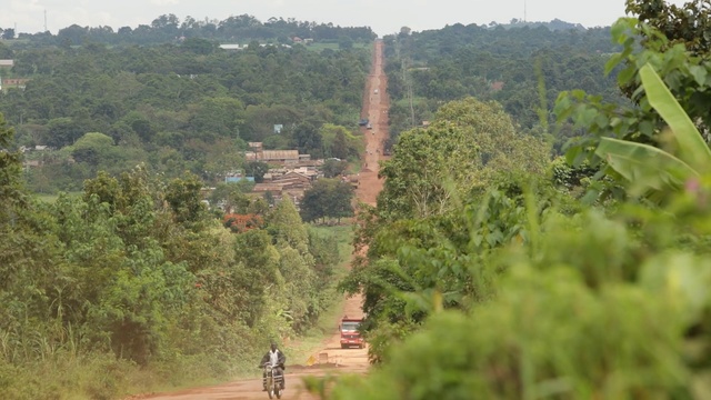 Video Reference: road, vegetation, tree, plant, path, rural area, hill station, hill, jungle, grass, Person