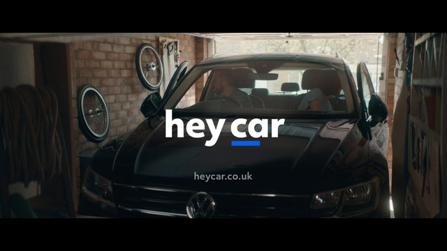 Video Reference: Land vehicle, Vehicle, Car, Volkswagen, Automotive design, Mid-size car, Hood, Headlamp, Sitting, Small, Black, Mirror, White, Riding, Bus, Wheel, Auto part, Automotive, Tire, Vehicle registration plate, Text, Vehicle door, Personal luxury car, Automotive exterior, Luxury vehicle, City car, Automotive lighting, Bumper