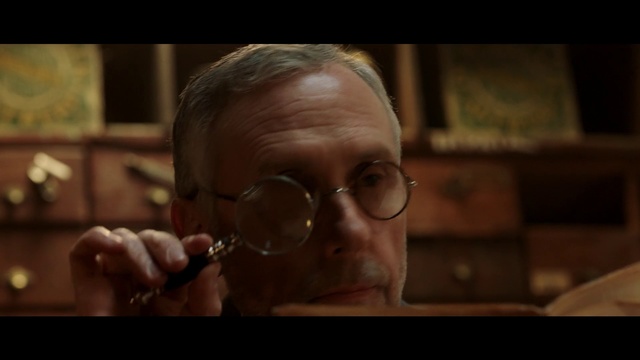 Video Reference: Face, Eyewear, Head, Nose, Glasses, Mouth, Cheek, Human, Close-up, Ear, Person, Indoor, Man, Looking, Front, Wearing, Shirt, Wine, Sitting, Holding, Glass, Food, Close, Human face, Goggles