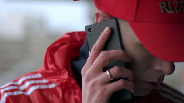 Video Reference: Red, Nose, Chin, Finger, Hand, Outerwear, Mouth, Jacket, Ear, Thumb, Person