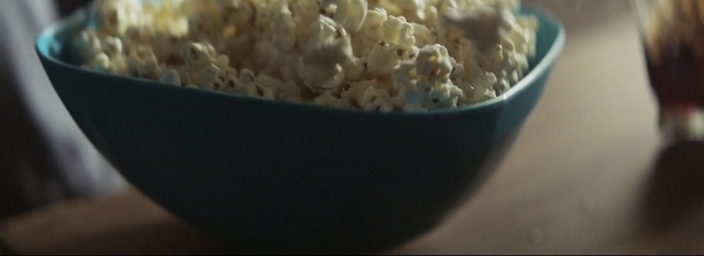 Video Reference: Popcorn, Kettle corn, Dish, Food, Snack, Cuisine, Ingredient, Recipe, Comfort food, Side dish, Indoor, Table, Bowl, Plate, Sitting, Rice, Cake, Filled, Broccoli, Black, Close, White, Large, Holding, Meat, Cooked