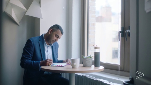 Video Reference: White-collar worker, Job, Office, Room, Businessperson, Sitting, Interior design, Employment, Desk, Conversation, Person, Indoor, Window, Man, Table, Looking, Front, Standing, Computer, Using, Young, Woman, Kitchen, Laptop, White, Holding, Phone, Clothing, Furniture, Vase