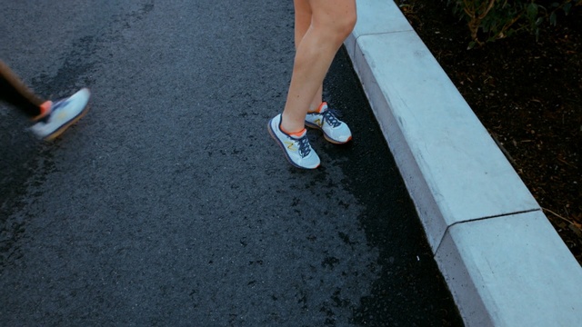 Video Reference: asphalt, footwear, shoe, leg, floor, road surface, foot, flooring, outdoor shoe, recreation