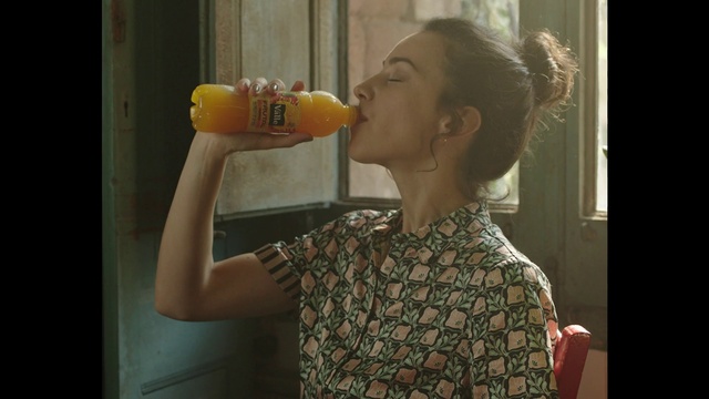 Video Reference: Human body, Neck, Gesture, Happy, Finger, Drinkware, Plastic bottle, Orange drink, Drinking, Drink