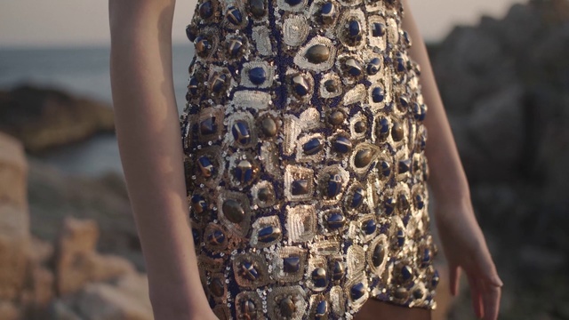 Video Reference: Fashion, Dress, Joint, Leg, Street fashion, Pattern, Fashion accessory, Haute couture, Cocktail dress, Person, Clothing, Young, Child, Boy, Holding, Little, Hand, Small, Girl, Woman, Cake, Man, Standing