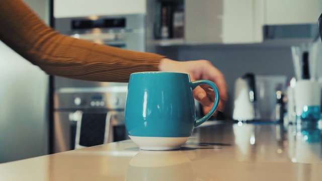 Video Reference: product, cup, coffee cup, furniture, glass, cup, interior design, Person