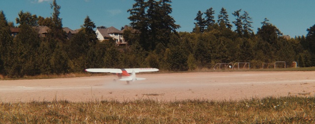 Video Reference: sky, field, tree, airplane, aviation, aircraft, vehicle, grass, water, plant