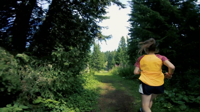 Video Reference: People in nature, Nature, Trail, Green, Jungle, Forest, Natural environment, Tree, Vegetation, Outdoor recreation, Outdoor, Person, Grass, Woman, Girl, Young, Riding, Yellow, Game, Frisbee, Field, Walking, Standing, Throwing, Shirt, Holding, Playing, Wearing, Park, Grassy, Street, Ball, Red, Catch, Clothing, Hiking, Plant, Wooded