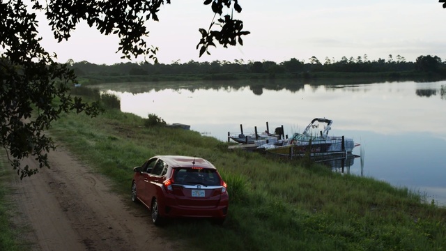 Video Reference: car, waterway, mode of transport, vehicle, lake, bank, river, reservoir, road, water