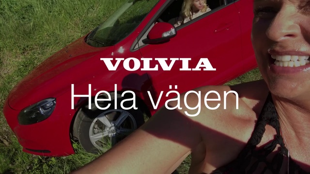 Video Reference: Land vehicle, Vehicle, Car, Vehicle door, Red, Compact car, Automotive wheel system, Automotive exterior, Automotive design, Wheel, Grass, Person, Outdoor, Woman, Wearing, Girl, Sign, Holding, Sitting, Hot, Young, Smiling, Dog, Standing, White, Hotdog, Text, Auto part