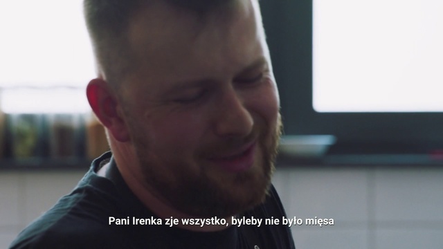 Video Reference: Face, Facial expression, Chin, Forehead, Cheek, Nose, Head, Neck, Jaw, Mouth, Person, Man, Indoor, Looking, Front, Holding, Sitting, Laptop, Food, Screen, Computer, Smiling, Glasses, Standing, Table, Shirt, Young, Phone, Woman, Human face, Screenshot, Selfie, Smile, Staring