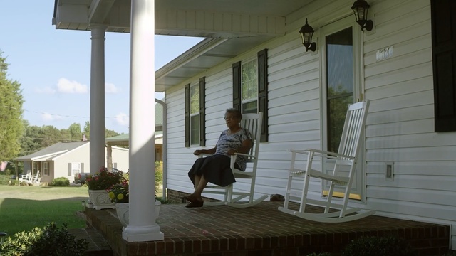 Video Reference: porch, house, siding, outdoor structure, home, window, deck, backyard, shade, real estate, Person