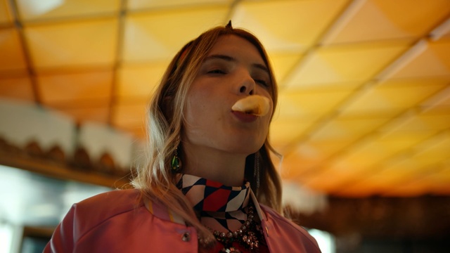 Video Reference: Hair, Fun, Smile, Mouth, Happy, Long hair, Neck, Brown hair, Person, Wearing, Indoor, Shirt, Orange, Young, Woman, Standing, Holding, Boy, Little, Red, Girl, Table, Man, Umbrella, Room, Blue, White, Human face, Clothing, Fashion accessory, Face, Lipstick, Necklace