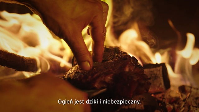 Video Reference: Heat, Flame, Hand, Fire, Cuisine, Person, Cake, Indoor, Nature, Chocolate, Table, Piece, Food, Sitting, Man, Fireplace, Cutting, Close, Cut, Birthday, Plate, Eating, Pan