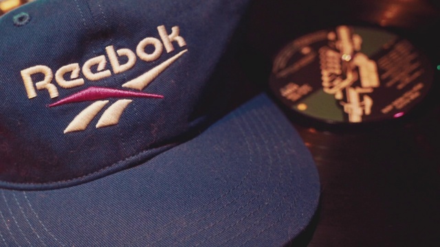 Video Reference: Cap, Baseball cap, Headgear, Hat, Trucker hat, Fashion accessory, Brand