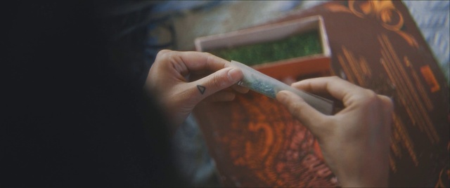 Video Reference: Hand, Finger, Nail, Flesh, Person, Indoor, Holding, Sitting, Using, Woman, Food, Front, Man, Table, Young, Shirt, Girl, Video, Remote, White, Playing, Glass, Game