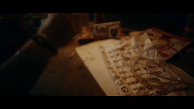 Video Reference: Black, Photograph, Darkness, Brown, Light, Text, Music, Font, Lighting, Wood, Indoor, Sitting, Table, Photo, Food, Laptop, Pizza, Room, Donut, Computer, Laying, Bed, Remote, White, Plate, Handwriting, Screenshot