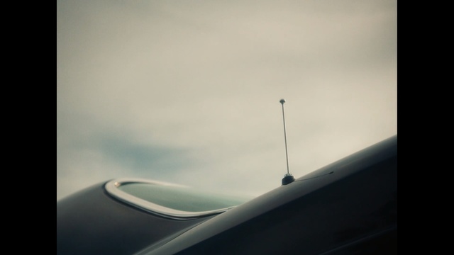 Video Reference: Sky, Cloud, Automotive exterior, Vehicle door, Line, Wing, Photography, Auto part, Air travel, Tints and shades, Sitting, Photo, Dark, Airplane, Plane, Cloudy, Table, Black, White, Large, Computer, Clock, Tower, Flying, Red, Cat, Air, Blue, Fog, Vehicle, Clouds