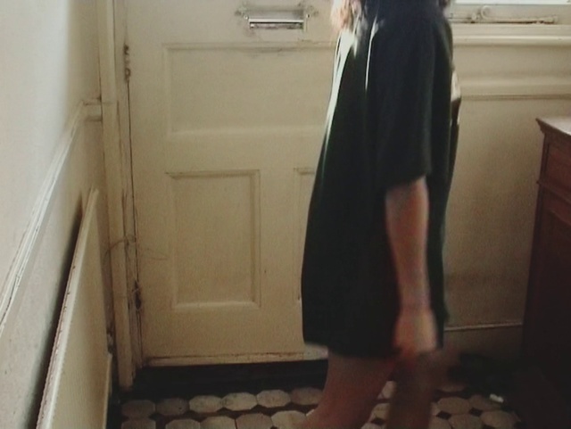 Video Reference: Clothing, Black, Floor, Room, Standing, Shoulder, Dress, Tile, Leg, Outerwear