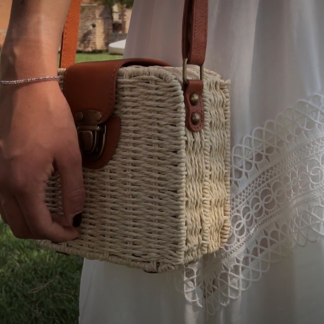 Video Reference: Wicker, Beige, Fashion accessory, Woven fabric, Crochet, Bag, Person, Grass, Sitting, Table, Woman, White, Holding, Phone, Standing