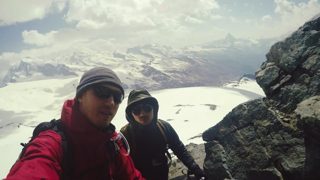 Video Reference: mountainous landforms, mountain, mountain range, ridge, wilderness, sky, outdoor recreation, adventure, mountaineering, cloud, Person