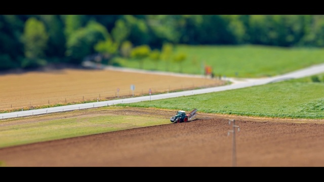 Video Reference: car, race track, green, field, grass, race, plain, road, line, sky