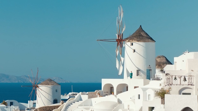 Video Reference: Windmill, Blue, Azure, Town, Architecture, Tourism, Building, Vacation, Roof, Wind, Person