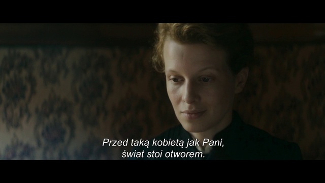 Video Reference: Human, Adaptation, Photo caption, Screenshot, Movie, Smile, Photography, Darkness, Flash photography, Portrait, Person, Indoor, Photo, Man, Looking, Front, Holding, Sitting, Young, Dark, Woman, Screen, Laptop, Shirt, White, Standing, Room, Sign, Text, Human face