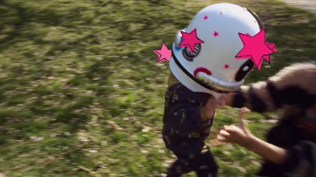 Video Reference: Head, Helmet, Cap, Toy, Happy, Grass, Plant, Glove, Party supply, Sports gear