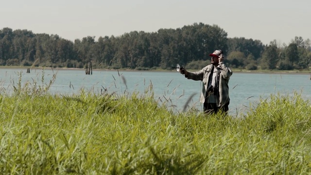 Video Reference: Water, Plant, Sky, People in nature, Natural landscape, Lake, Tree, Hat, Grass, Bank