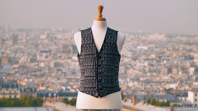 Video Reference: Clothing, Outerwear, Hairstyle, Shoulder, Eyewear, Building, Tartan, Dress shirt, Street fashion, Neck