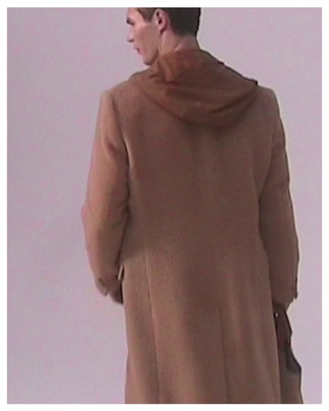 Video Reference: Outerwear, Overcoat, Coat, Sleeve, Gesture, Waist, Collar, Headgear, Suit, Blazer