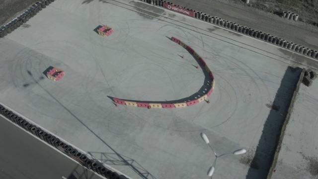 Video Reference: Asphalt, Automotive tire, Road surface, Urban design, Recreation, Landscape, Concrete, Font, Sport venue, Circle