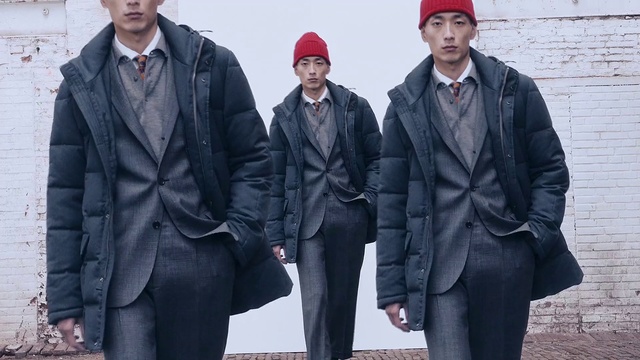 Video Reference: Face, Overcoat, Cap, Black, Sleeve, Standing, Headgear, Street fashion, Hat, Collar