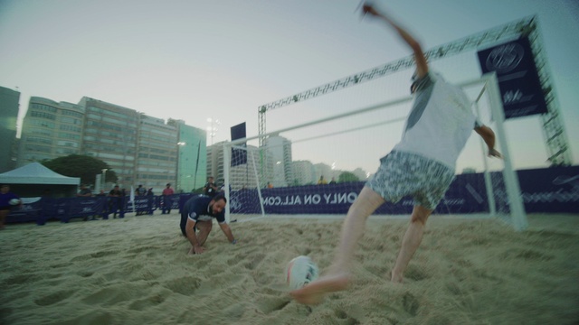 Video Reference: Sky, Shorts, Trunks, People on beach, Building, Sports equipment, Net sports, Volleyball net, Ball, Beach volleyball