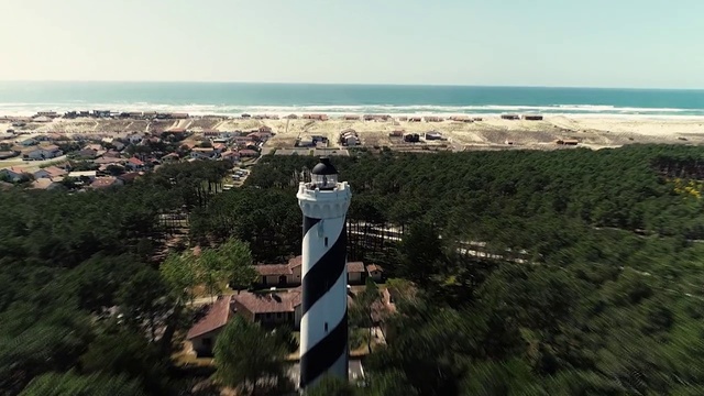 Video Reference: Sky, Water, Tree, Tower, Terrain, Landscape, Horizon, Lighthouse, Plant, Urban design
